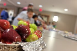 Religious school students picking up supplies to make Rosh Hashanah gift bags