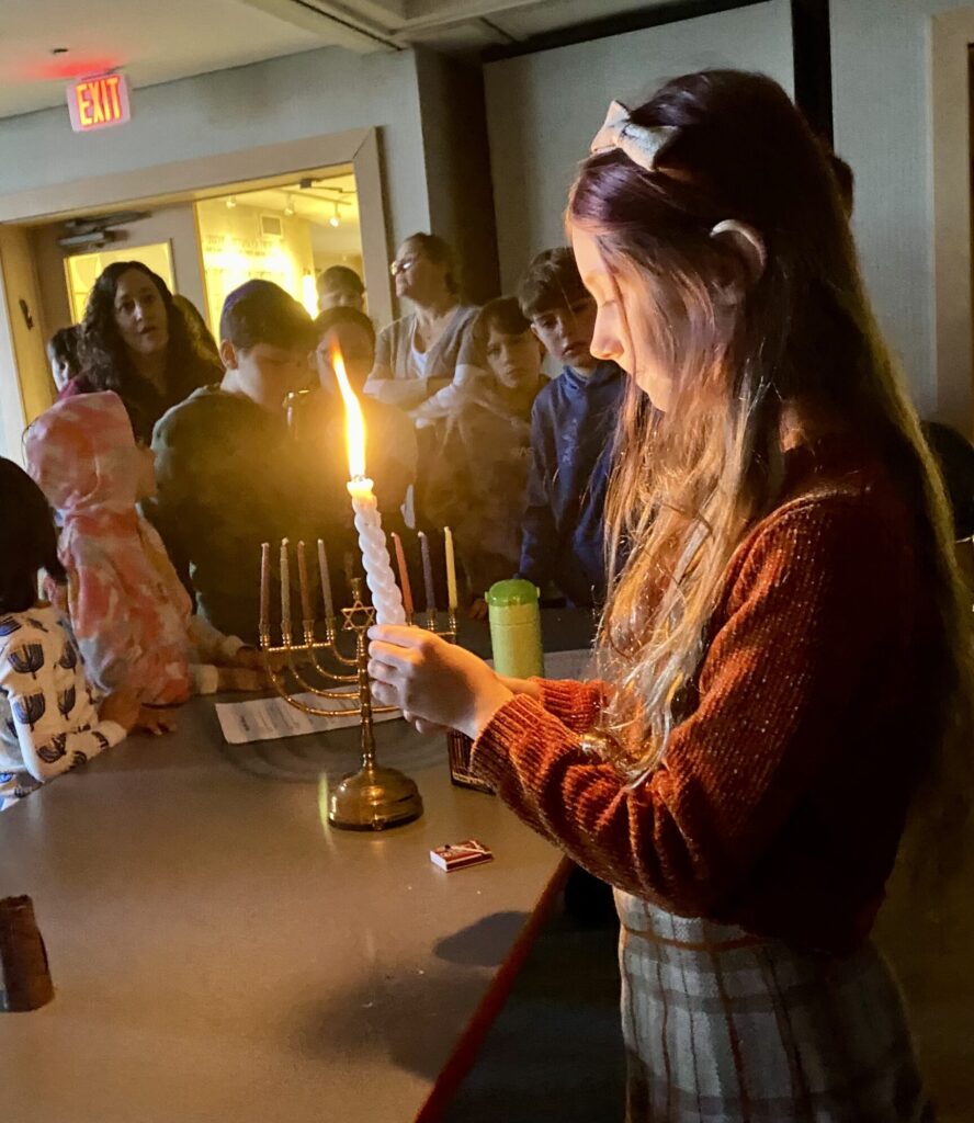 student holding Havdalah candle